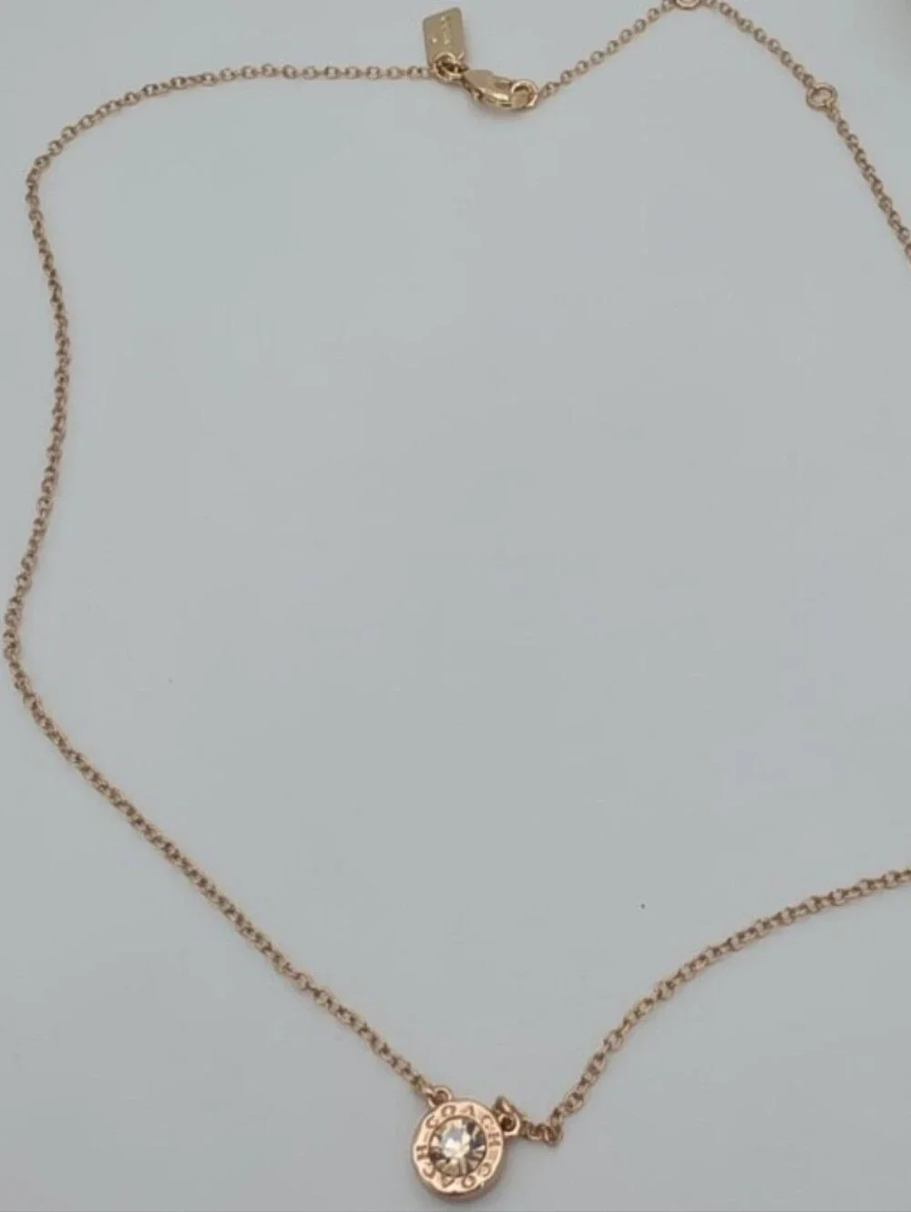 COACH Rose Gold Crystal Logo Disc Necklace